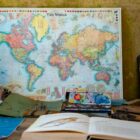 world map poster near book and easel