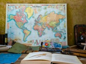 world map poster near book and easel