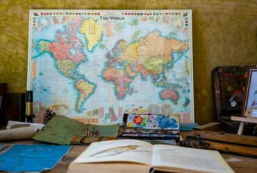 world map poster near book and easel