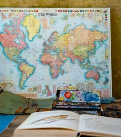 world map poster near book and easel