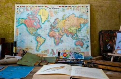 world map poster near book and easel