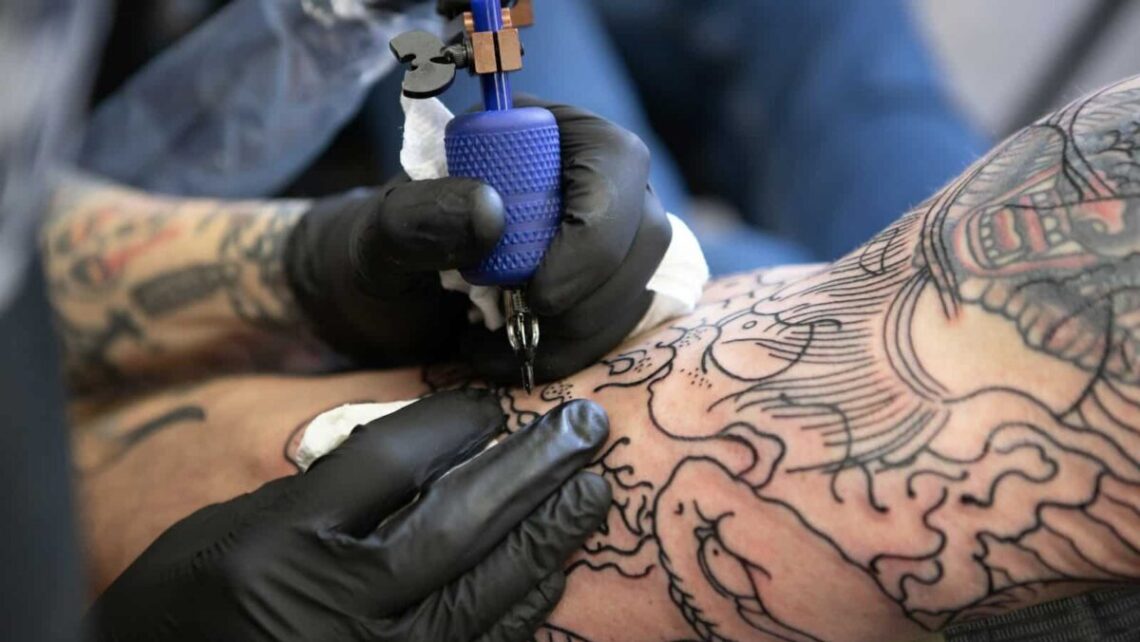 person with tattoo on right arm