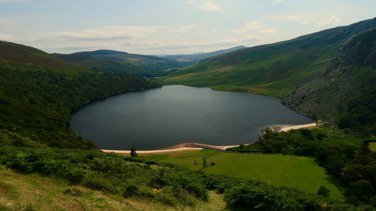 A large lake surrounded by lush green hills